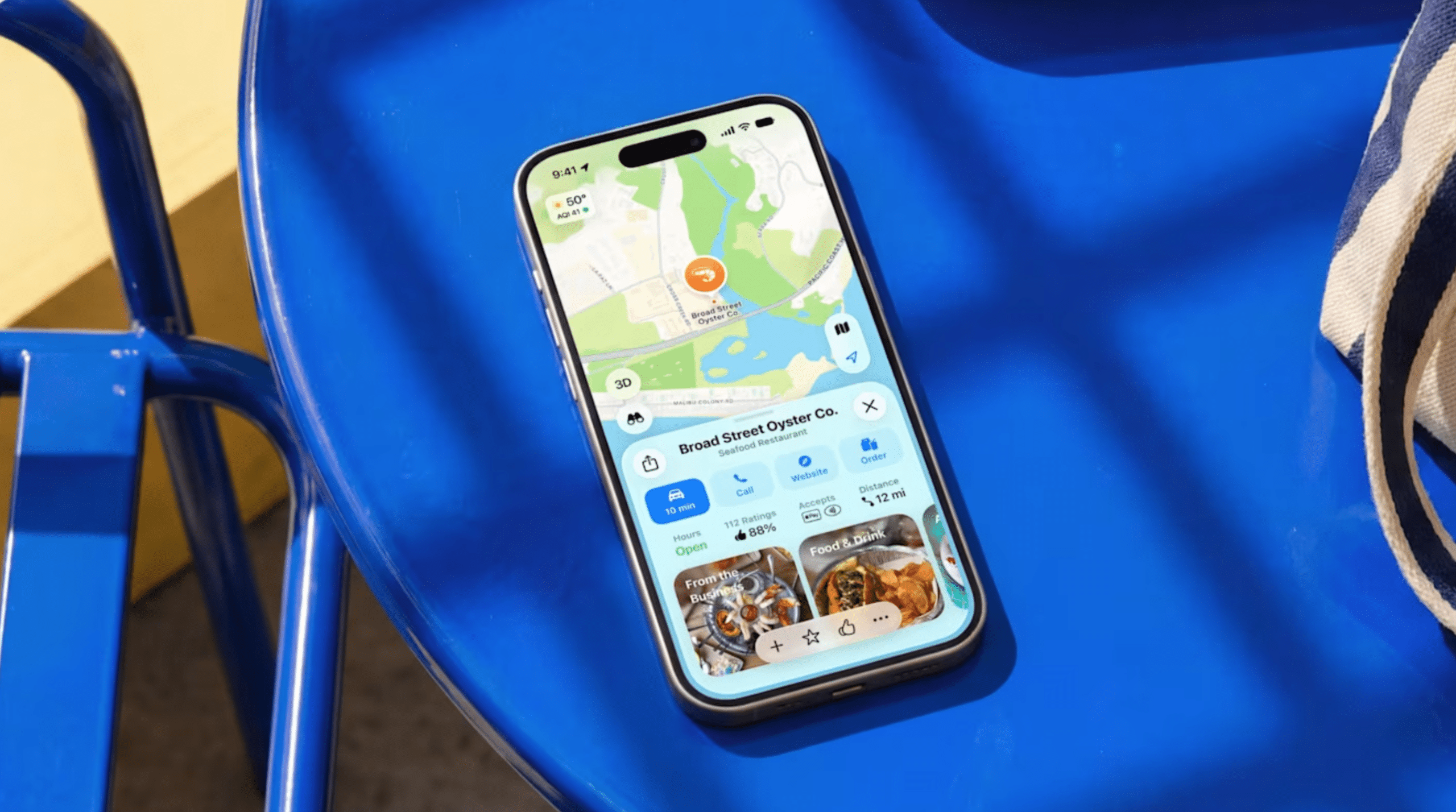iPhone displaying Apple Maps on a blue chair.