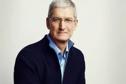 Portrait of a gray-haired man wearing glasses and a dark sweater.