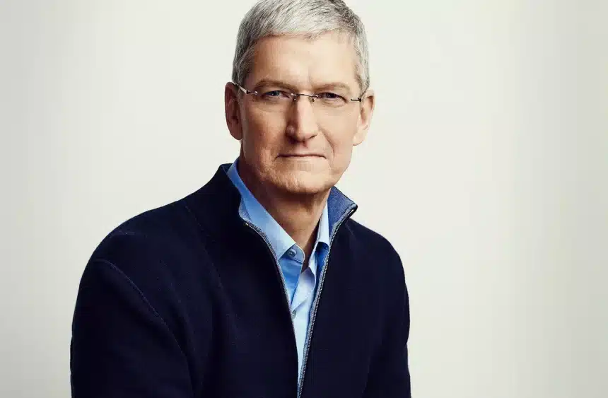 Portrait of a gray-haired man wearing glasses and a dark sweater.