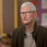 Gray-haired man wearing glasses during an interview.