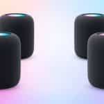 Four black HomePod speakers arranged in a surround sound setup.