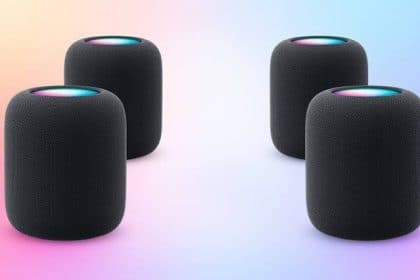 Four black HomePod speakers arranged in a surround sound setup.