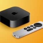 Black Apple TV 4K streaming device with a silver Siri Remote on a yellow background.