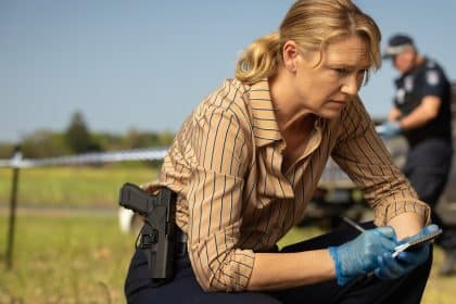 Detective investigating a crime scene in the Australian drama Dustfall.