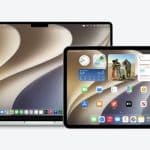 Apple MacBook, iPad, iPhone, and Apple Watch displayed together with their screens on.