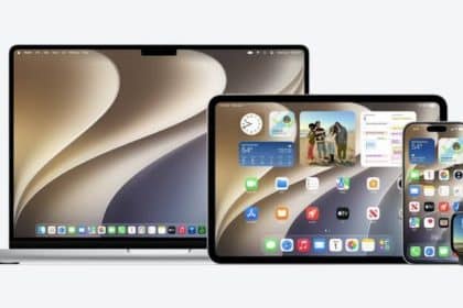 Apple MacBook, iPad, iPhone, and Apple Watch displayed together with their screens on.