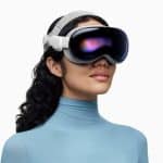 Woman wearing an Apple Vision Pro headset against a white background.
