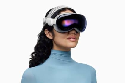 Woman wearing an Apple Vision Pro headset against a white background.
